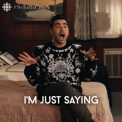 A Man Is Sitting On A Bed With His Mouth Open And The Words I 'M Just Saying Below Him GIF