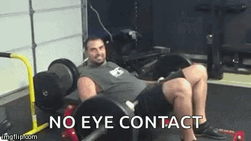 A Man Is Sitting On A Bench In A Gym With The Words `` No Eye Contact '' Written Next To Him . GIF