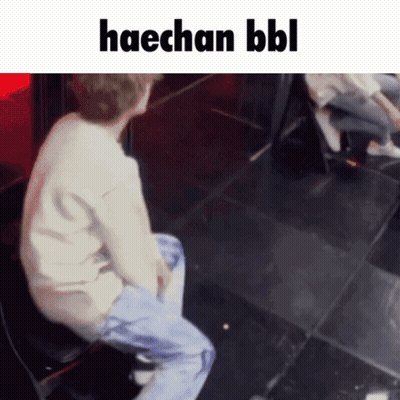 A Man Is Sitting On A Chair With The Words Haechan Bbl Written Above Him GIF