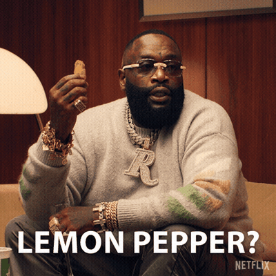 A Man Is Sitting On A Couch And Holding A Chicken Nugget And The Caption Says Lemon Pepper GIF