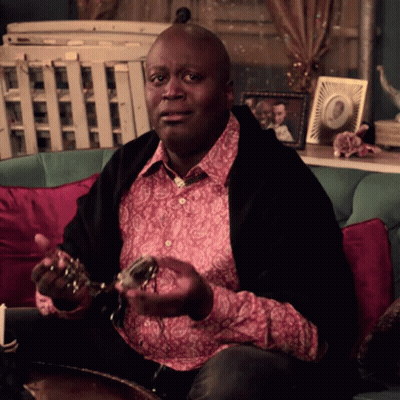 A Man Is Sitting On A Couch Holding A Pair Of Keys GIF