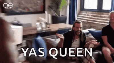 A Man Is Sitting On A Couch In A Living Room With The Words Yas Queen Written On The Screen . GIF