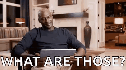 A Man Is Sitting On A Couch Using A Tablet Computer And Asking What Are Those . GIF