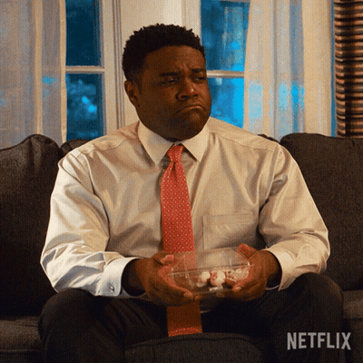 A Man Is Sitting On A Couch With A Netflix Logo On The Bottom GIF