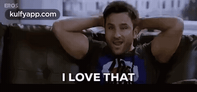 A Man Is Sitting On A Couch With His Hands Behind His Head And Says I Love That . GIF