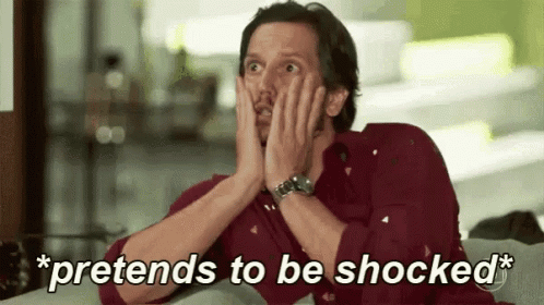 A Man Is Sitting On A Couch With His Hands On His Face And The Words `` Pretends To Be Shocked '' Above Him . GIF