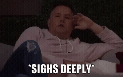 A Man Is Sitting On A Couch With His Hands On His Head And The Words `` Sighs Deeply '' Written Next To Him . GIF