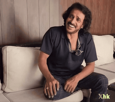 A Man Is Sitting On A Couch With The Letters Xhk On The Bottom GIF