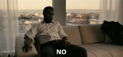 A Man Is Sitting On A Couch With The Word No Written On The Bottom GIF