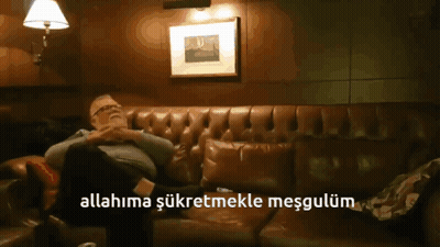 A Man Is Sitting On A Couch With The Words Allahima Şükretmekle Mesgulum Above Him GIF