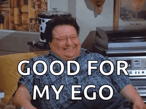 A Man Is Sitting On A Couch With The Words Good For My Ego Written On His Face GIF
