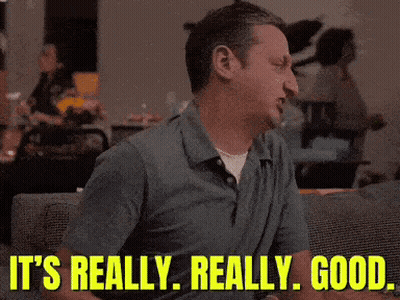 A Man Is Sitting On A Couch With The Words It 'S Really Really Good Behind Him GIF