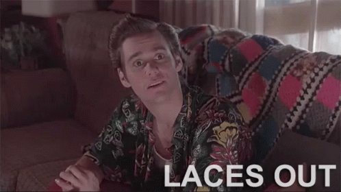 A Man Is Sitting On A Couch With The Words `` Laces Out '' Written On The Screen . GIF