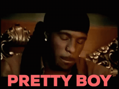A Man Is Sitting On A Couch With The Words Pretty Boy Behind Him GIF