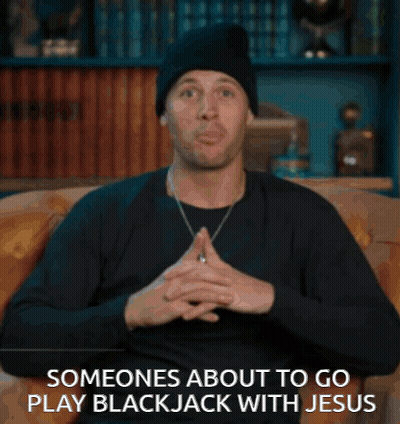 A Man Is Sitting On A Couch With The Words Someones About To Go Play Blackjack With Jesus GIF