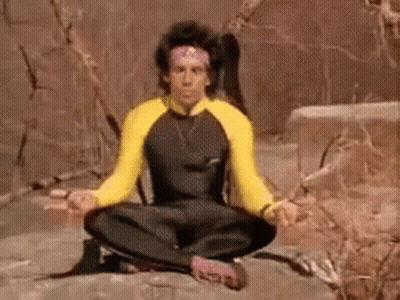 A Man Is Sitting On A Rock In A Lotus Position . GIF
