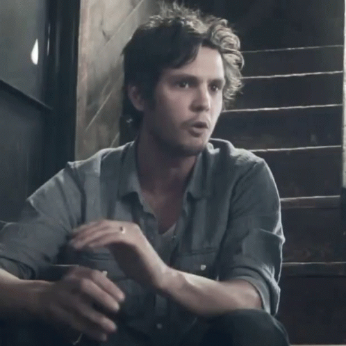 A Man Is Sitting On A Set Of Stairs With The Word Wussy Written On The Bottom GIF