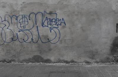 A Man Is Sitting On A Skateboard On A Wall With Graffiti On It That Says Destroy GIF