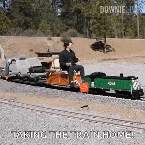 A Man Is Sitting On A Small Train With The Words " Taking The Train Home " On The Bottom GIF