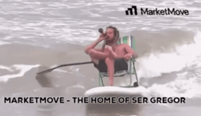 A Man Is Sitting On A Surfboard In The Ocean While Drinking From A Bottle . GIF