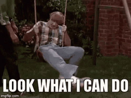 A Man Is Sitting On A Swing With The Words `` Look What I Can Do '' Above Him . GIF