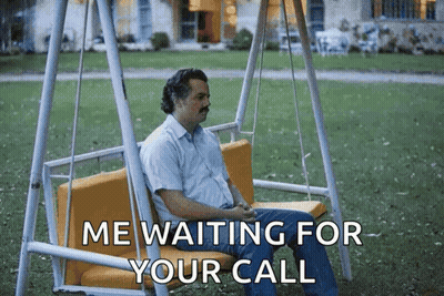 A Man Is Sitting On A Swing With The Words Me Waiting For Your Call Below Him GIF