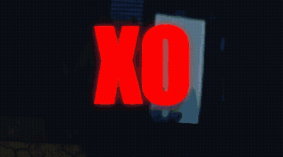 A Man Is Sitting On A Wall With The Word Xo In Red GIF