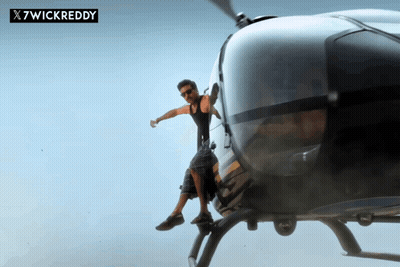 A Man Is Sitting On The Back Of A Helicopter With X7wickreddy Written On The Bottom GIF