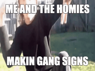 A Man Is Sitting On The Ground With His Arms In The Air And A Meme That Says Me And The Homies Makin Gang Signs GIF