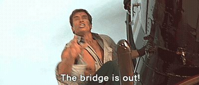 A Man Is Sitting On The Side Of A Building With The Words `` The Bridge Is Out '' Written On His Face . GIF