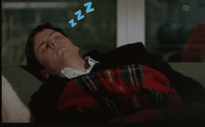 A Man Is Sleeping On A Couch With Zzz Above His Head GIF