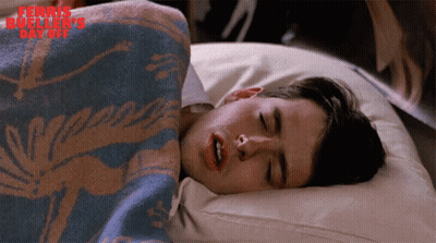 A Man Is Sleeping Under A Blanket With The Words Ferris Bueller 'S Day Off Written On The Bottom GIF