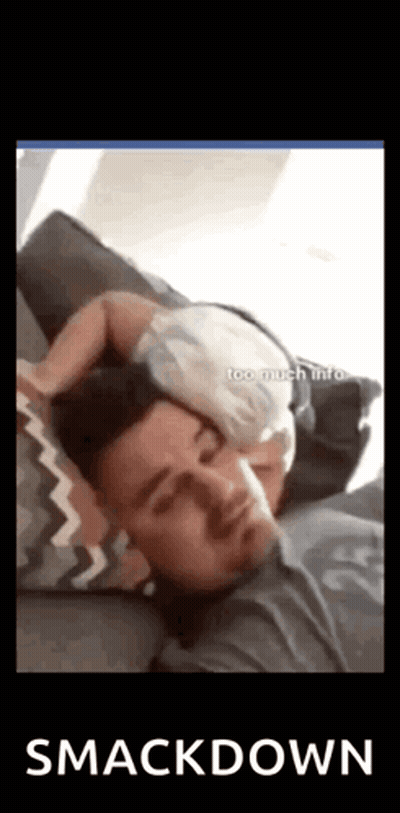 A Man Is Sleeping With A Baby On His Head . GIF