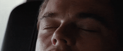 A Man Is Sleeping With His Eyes Closed In A Car Seat GIF