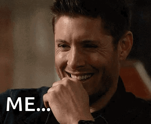 A Man Is Smiling And Covering His Mouth With His Hand And The Word Me Is Visible GIF