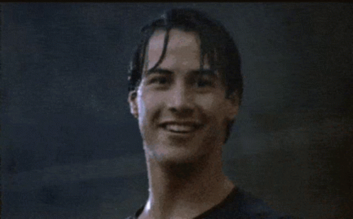 A Man Is Smiling And Giving A Thumbs Up GIF