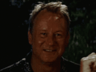 A Man Is Smiling And Holding A Piece Of Paper GIF