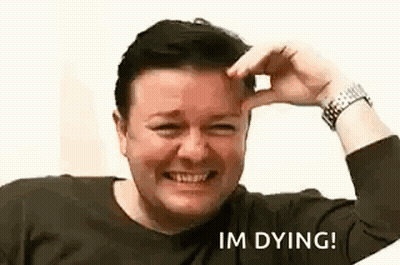 A Man Is Smiling And Holding His Hand To His Forehead While Making A Funny Face . GIF