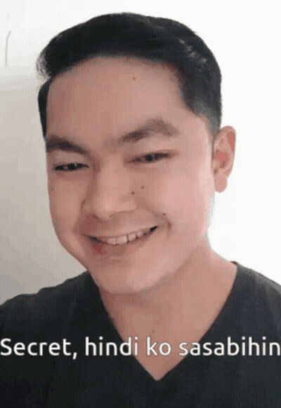 A Man Is Smiling And Making A Funny Face With The Words Secret , Hindi Ko Sasabihin . GIF