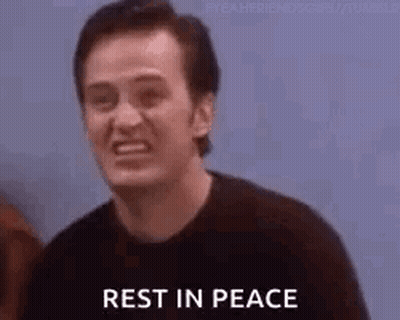 A Man Is Smiling And Saying `` Rest In Peace '' While Standing In Front Of A Group Of People . GIF