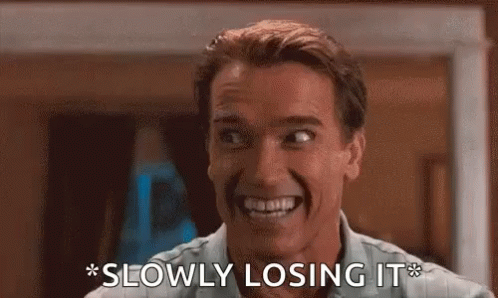 A Man Is Smiling And Saying `` Slowly Losing It '' While Making A Funny Face . GIF