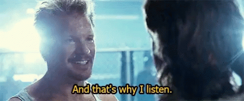 A Man Is Smiling And Talking To Another Man In A Movie . GIF