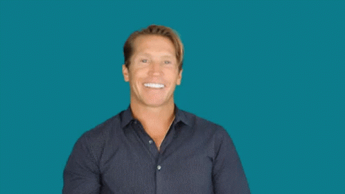 A Man Is Smiling And Waving With The Words Swoosh Above Him GIF