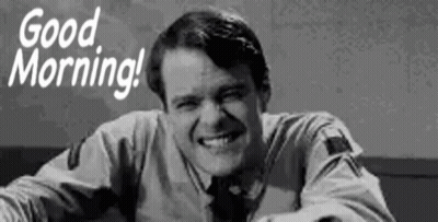 A Man Is Smiling In A Black And White Photo With The Words `` Good Morning '' . GIF