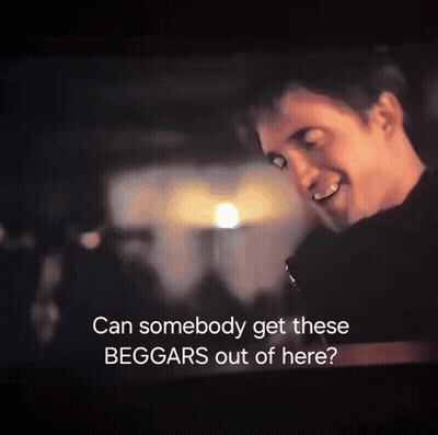 A Man Is Smiling In A Dark Room With The Words " Can Somebody Get These Beggars Out Of Here " GIF