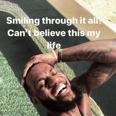 A Man Is Smiling In A Pool With The Words Smiling Through It All Can 'T Believe This My Life Below Him GIF