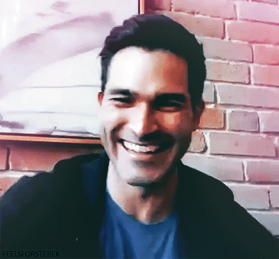 A Man Is Smiling In Front Of A Brick Wall With The Words Feelsforsterek Written Below Him GIF