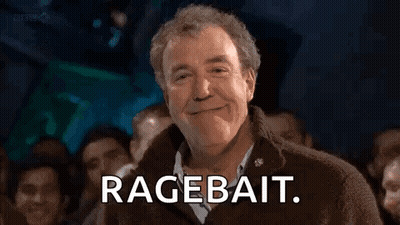 A Man Is Smiling In Front Of A Crowd Of People And Saying `` Ragebait '' . GIF