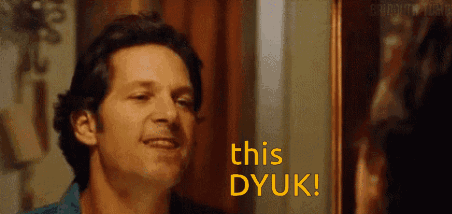 A Man Is Smiling In Front Of A Mirror With The Words This Dyuk Written On It . GIF
