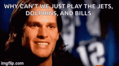 A Man Is Smiling In Front Of A Sign That Says Why Can 'T We Just Play The Jets GIF